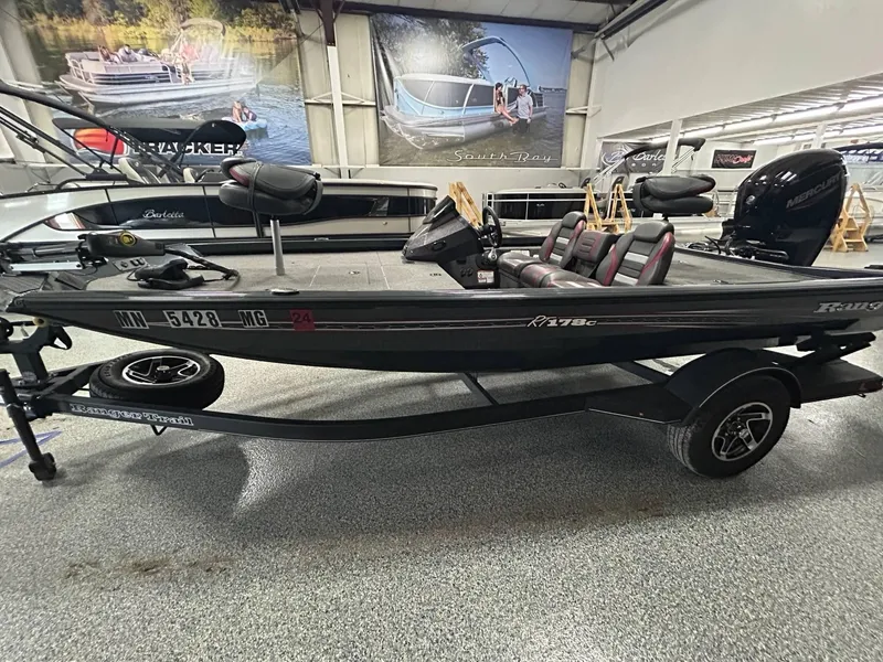 Slide: The Image of 2022 Ranger RT178C fishing boat with Mercury engine displayed indoors. - 6