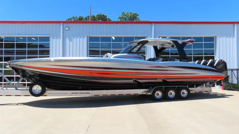 Slide: The Image of 2020 MTI 42V speedboat with vibrant orange and black design on a trailer. - 0
