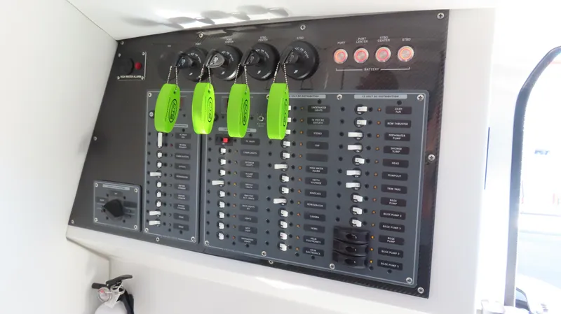Slide: The Image of Control panel of a 2020 MTI 42V boat with switches and green key tags. - 17