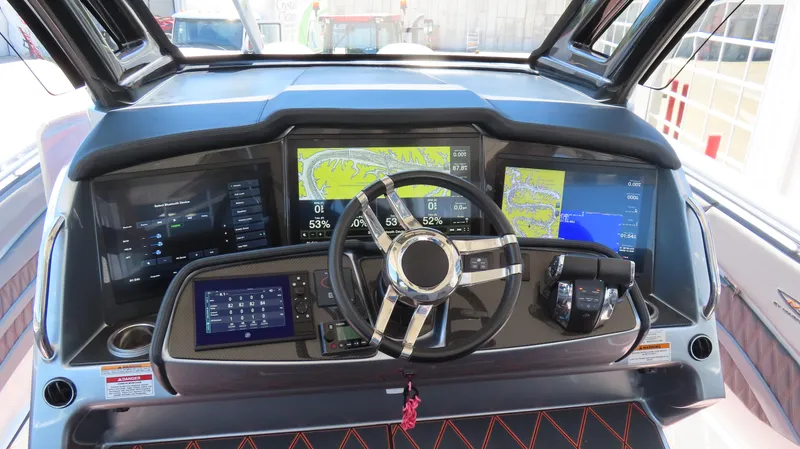 Slide: The Image of Control panel of a 2020 MTI 42V boat with advanced navigation displays and steering wheel. - 21