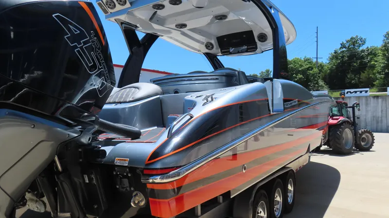 Slide: The Image of 2020 MTI 42V powerboat with vibrant orange accents and powerful outboard engine. - 5