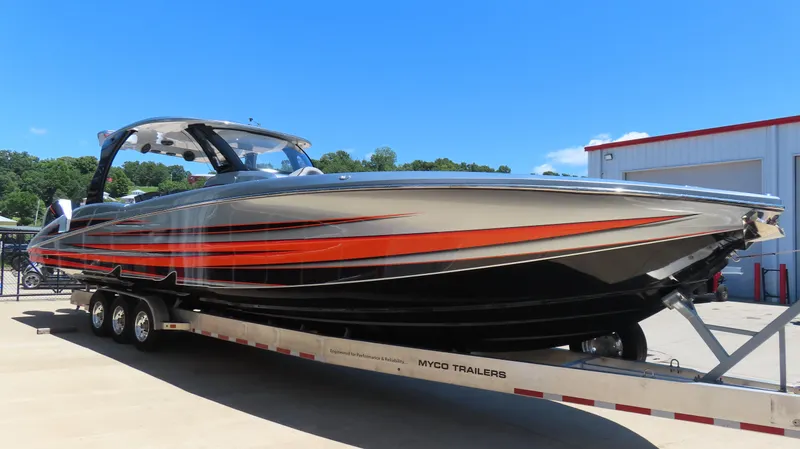 Slide: The Image of 2020 MTI 42V boat with orange and black design on a trailer. - 7
