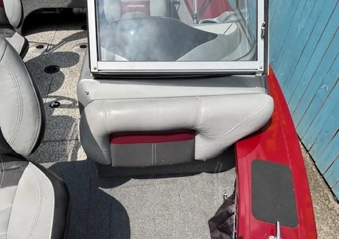 Slide: The Image of 2015 Tracker Targa V-18 Combo boat interior with gray seating and red accents. - 14