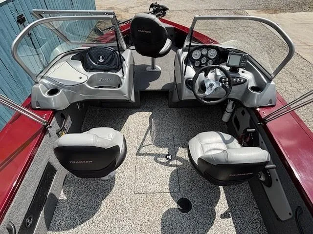 Slide: The Image of 2015 Tracker Targa V-18 Combo boat interior with seating and dashboard controls. - 15