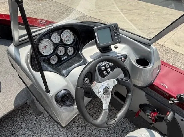 Slide: The Image of 2015 Tracker Targa V-18 Combo boat dashboard with steering wheel and gauges. - 18