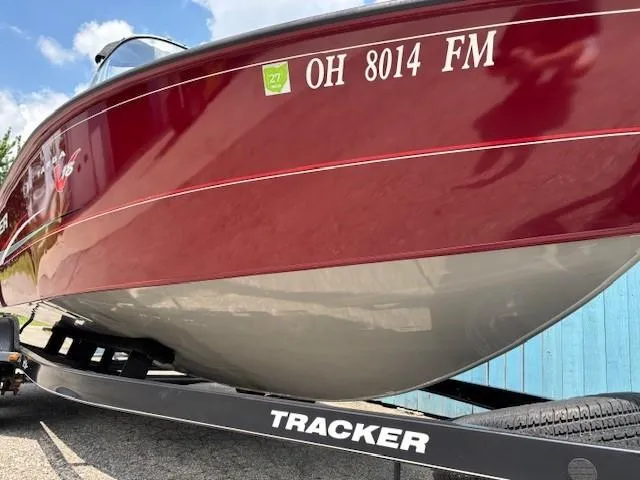 Slide: The Image of 2015 Tracker Targa V-18 Combo boat on trailer, red hull, registration OH 8014 FM. - 2
