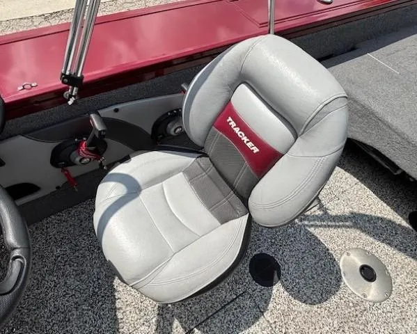 Slide: The Image of 2015 Tracker Targa V-18 Combo boat seat with gray upholstery and red accents. - 20