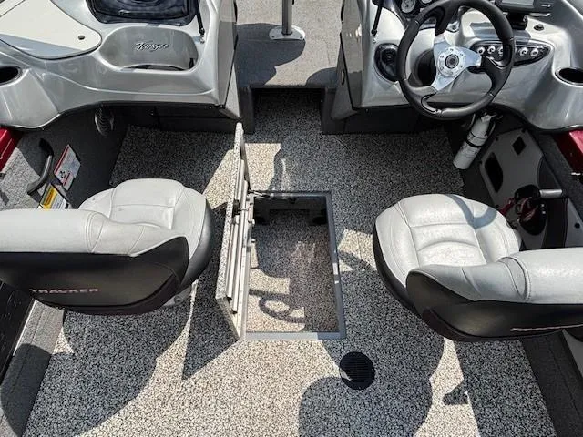 Slide: The Image of 2015 Tracker Targa V-18 Combo boat interior with two seats and open storage compartment. - 22