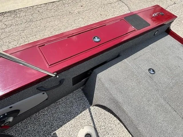 Slide: The Image of 2015 Tracker Targa V-18 Combo boat interior with red panel and gray carpet. - 24