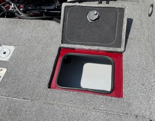 Slide: The Image of Open storage compartment on 2015 Tracker Targa V-18 Combo boat deck. - 32