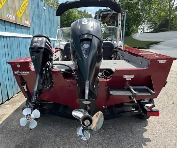 Slide: The Image of 2015 Tracker Targa V-18 Combo boat, rear view, dual outboard motors, red exterior. - 5