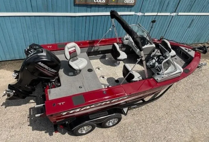 Slide: The Image of 2015 Tracker Targa V-18 Combo boat with Mercury engine, red exterior, parked on trailer. - 7