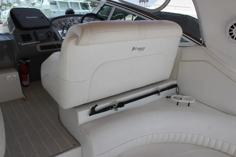 Slide: The Image of 2005 Cruisers Yachts 370 Express interior with white seating and control panel. - 10