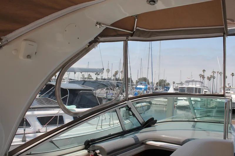 Slide: The Image of Interior view of 2005 Cruisers Yachts 370 Express, overlooking marina with boats and palm trees. - 11