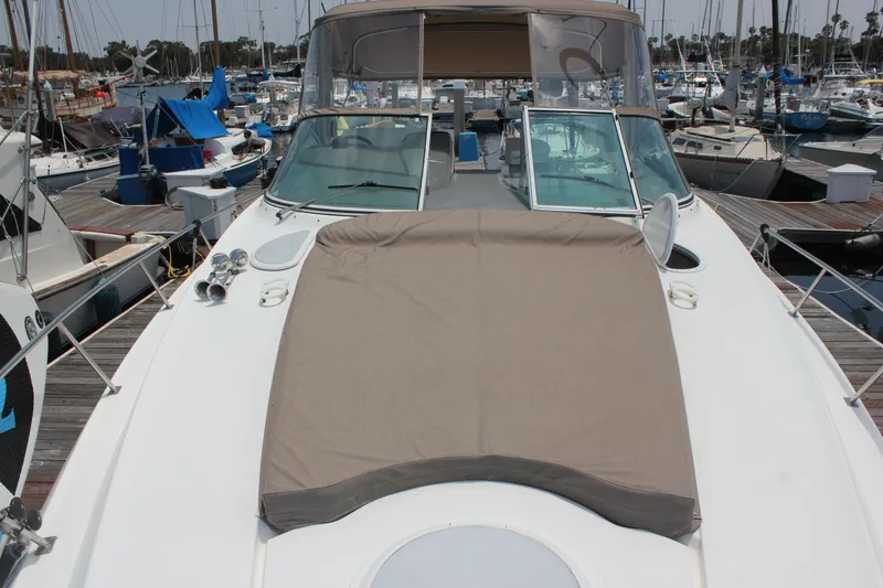 Slide: The Image of 2005 Cruisers Yachts 370 Express docked at marina, featuring spacious deck and sunpad. - 15