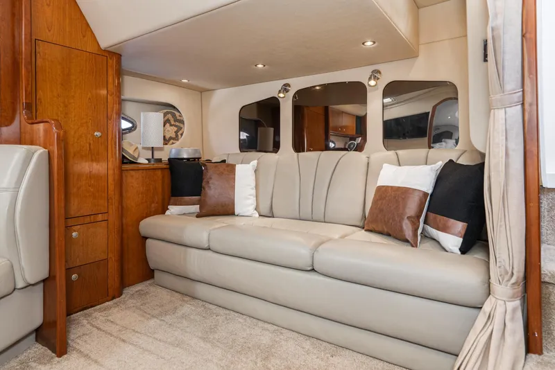 Slide: The Image of Luxurious interior of 2005 Cruisers Yachts 370 Express with beige leather seating and wooden accents. - 22