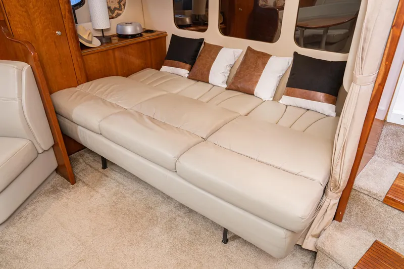 Slide: The Image of Luxurious interior of 2005 Cruisers Yachts 370 Express with beige leather seating and decorative pillows. - 23