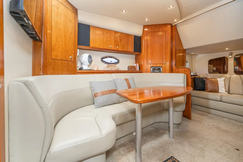 Slide: The Image of Luxurious interior of 2005 Cruisers Yachts 370 Express with elegant seating and wooden cabinetry. - 26