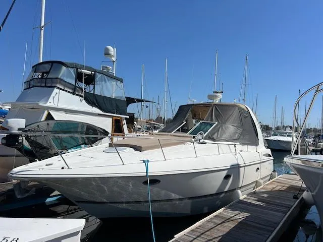 Slide: The Image of 2005 Cruisers Yachts 370 Express docked at marina under clear blue sky. - 3