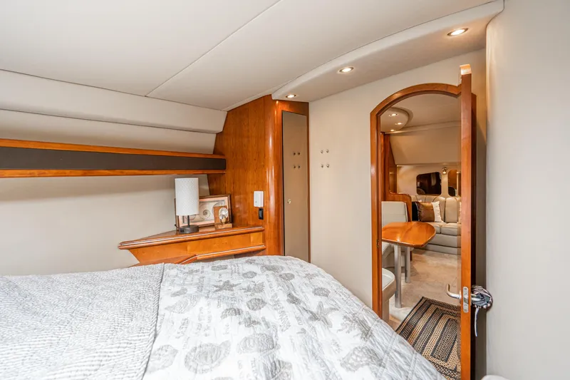 Slide: The Image of Luxurious interior of 2005 Cruisers Yachts 370 Express, featuring cozy bedroom and elegant wood finishes. - 30