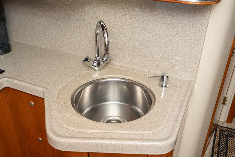 Slide: The Image of 2005 Cruisers Yachts 370 Express kitchen sink with modern faucet and countertop. - 33