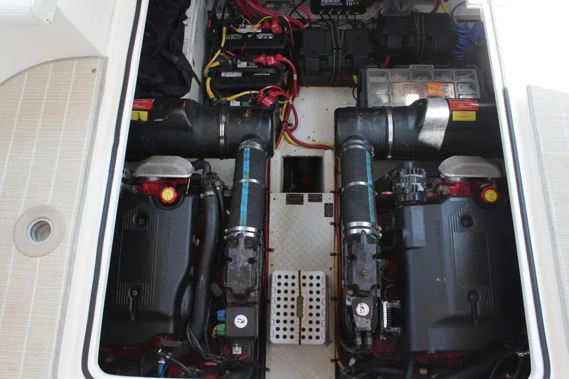 Slide: The Image of Engine compartment of 2005 Cruisers Yachts 370 Express, featuring dual engines and battery setup. - 36