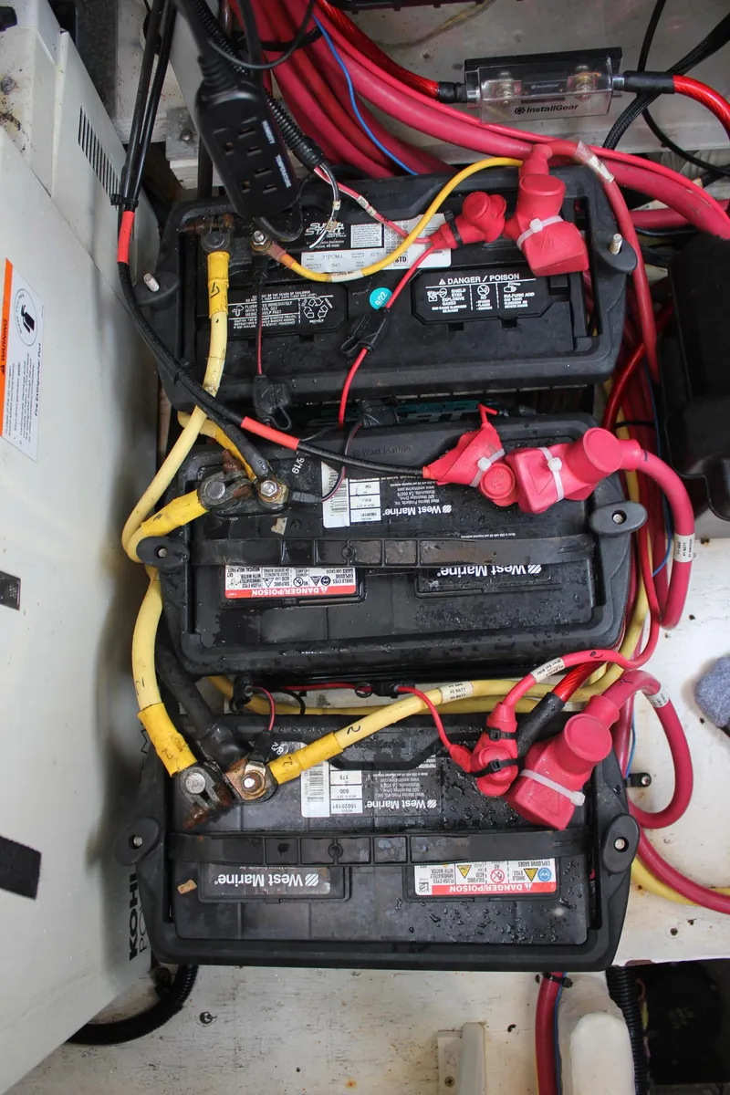 Slide: The Image of Battery setup in a 2005 Cruisers Yachts 370 Express with red and yellow cables. - 37