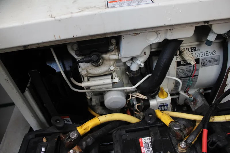 Slide: The Image of Engine compartment of a 2005 Cruisers Yachts 370 Express, featuring mechanical components and wiring. - 41