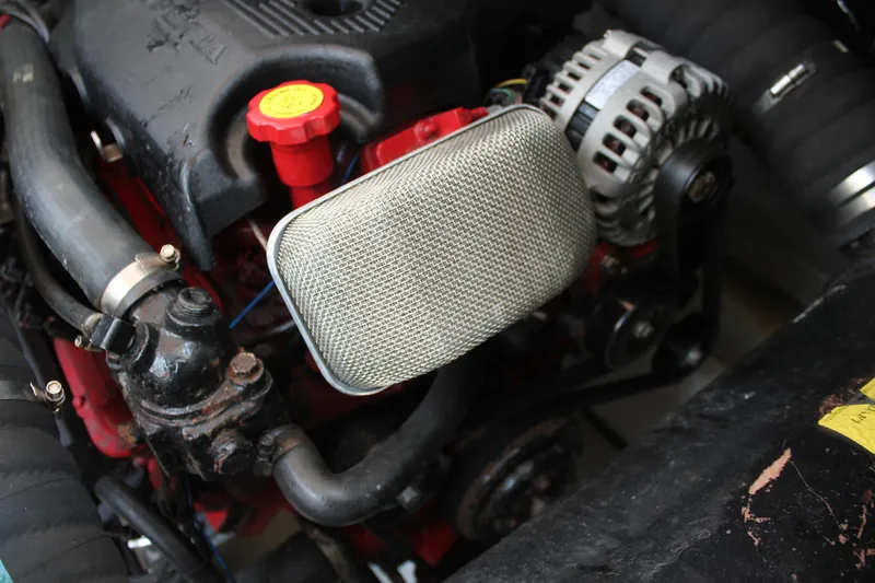 Slide: The Image of Engine components of a 2005 Cruisers Yachts 370 Express, featuring alternator and hoses. - 44