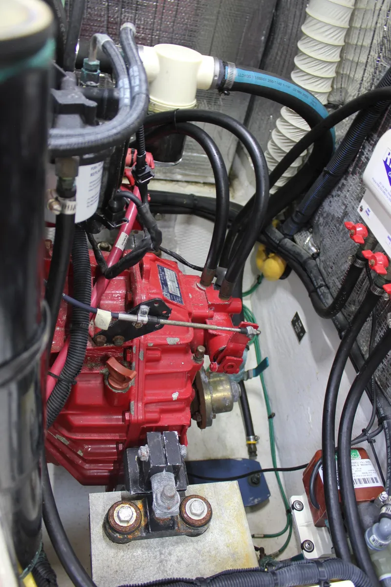 Slide: The Image of Engine compartment of 2005 Cruisers Yachts 370 Express with visible red machinery and hoses. - 45