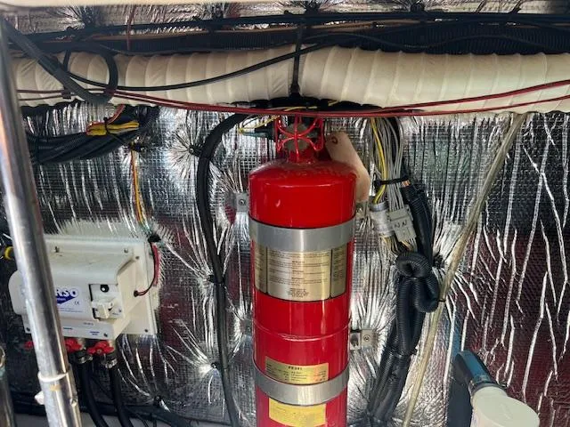 Slide: The Image of Engine room of 2005 Cruisers Yachts 370 Express with fire extinguisher and wiring. - 52