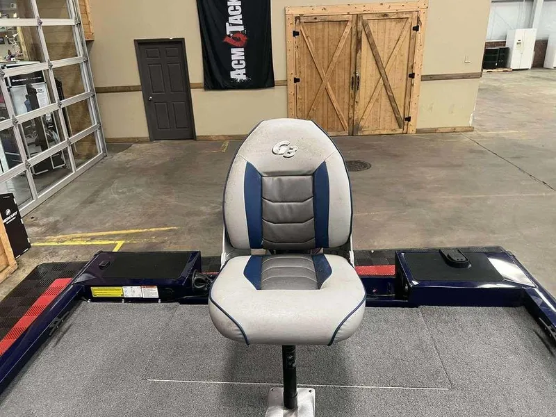 Slide: The Image of 2018 G3 Sportsman 17 boat seat in a showroom with wooden doors and banner. - 7