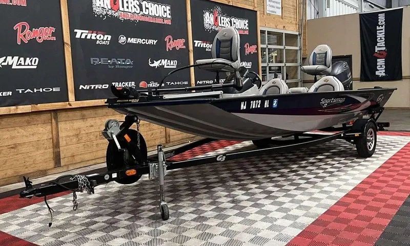 Slide: The Image of 2018 G3 Sportsman 17 boat on display in showroom with promotional banners. - 8