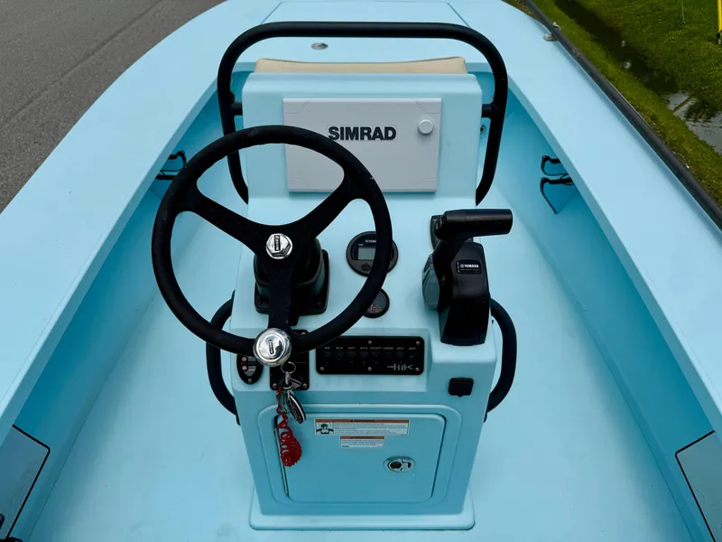 Slide: The Image of 2021 Hell's Bay Marquesa boat console with steering wheel and Simrad display. - 10