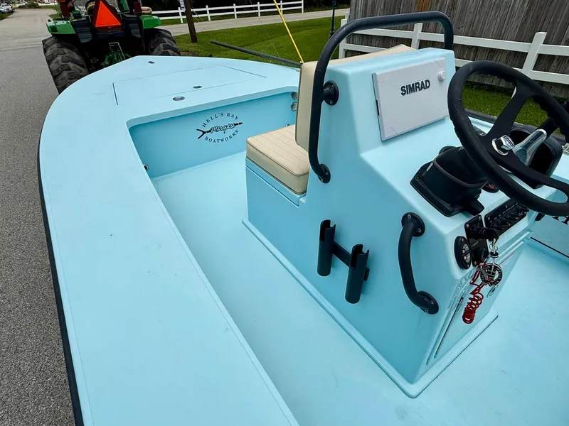 Slide: The Image of 2021 Hell's Bay Marquesa boat interior with steering console and Simrad electronics. - 11