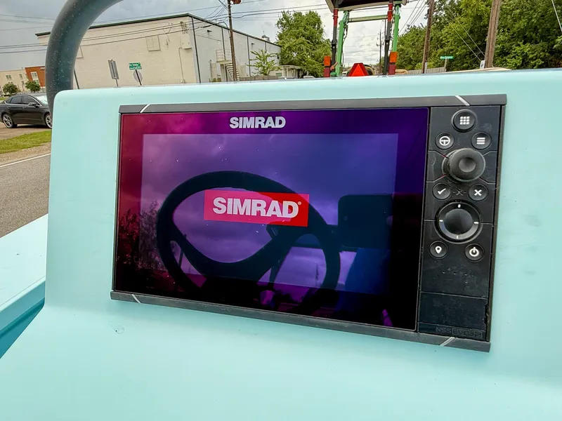 Slide: The Image of Simrad display on 2021 Hell's Bay Marquesa boat dashboard, showing steering wheel reflection. - 15