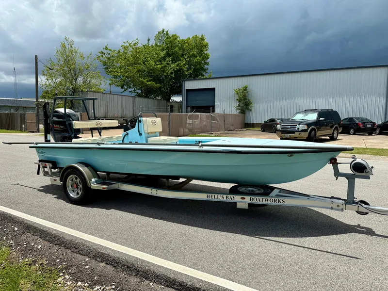 Slide: The Image of 2021 Hell's Bay Marquesa boat on trailer, parked outdoors under cloudy sky. - 5
