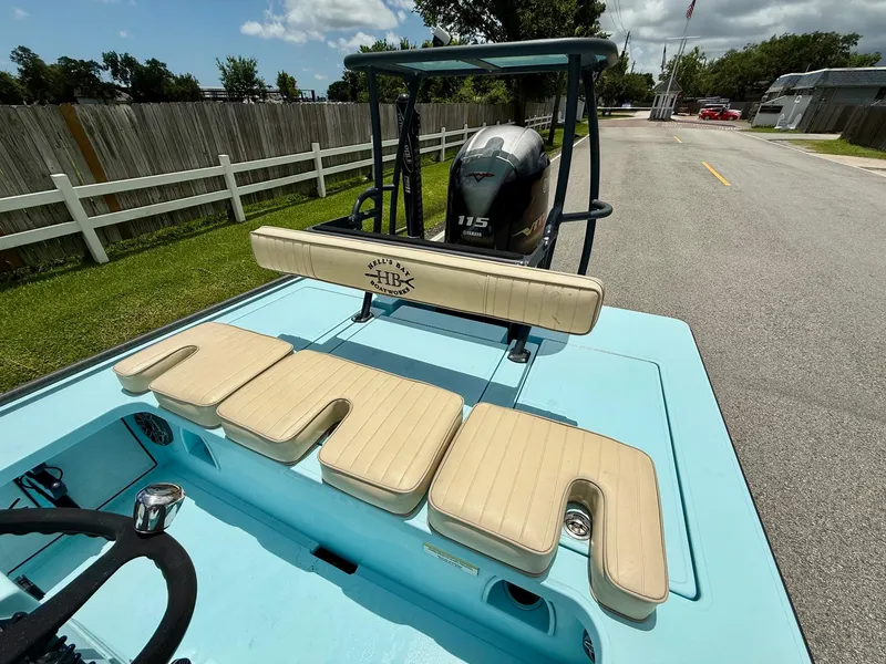 Slide: The Image of 2021 Hell's Bay Marquesa boat with Yamaha 115 engine, light blue deck, and beige seating. - 7