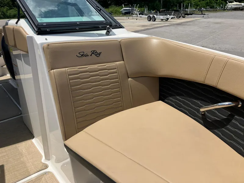 Slide: The Image of 2023 Sea Ray SPX 230 boat interior with tan leather seating and sleek design. - 10
