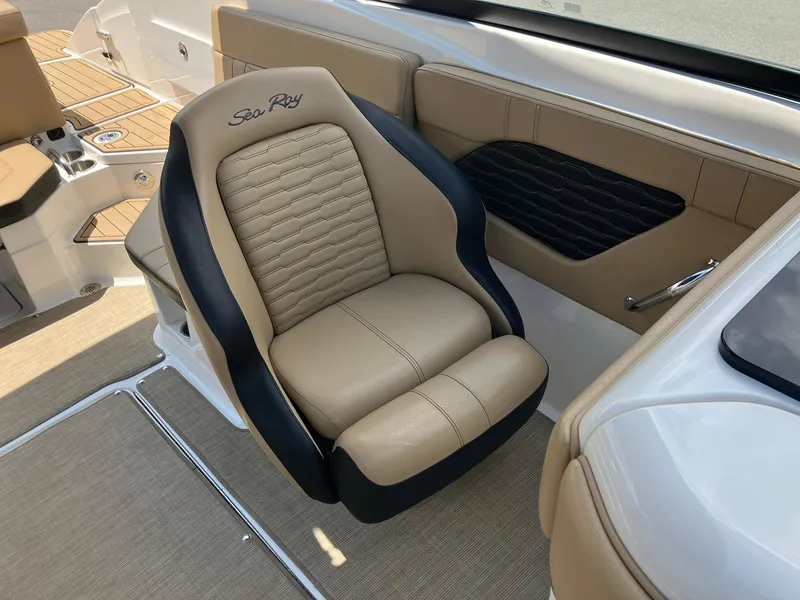 Slide: The Image of 2023 Sea Ray SPX 230 boat interior with tan and black seating. - 12