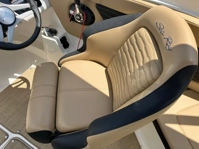 Slide: The Image of 2023 Sea Ray SPX 230 boat interior with tan and black seating. - 13