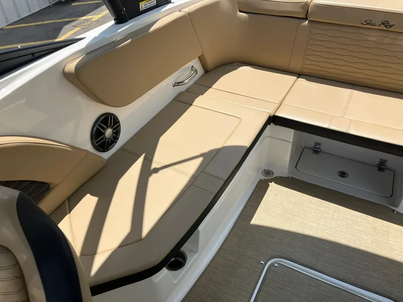 Slide: The Image of 2023 Sea Ray SPX 230 boat interior with beige seating and speaker. - 15
