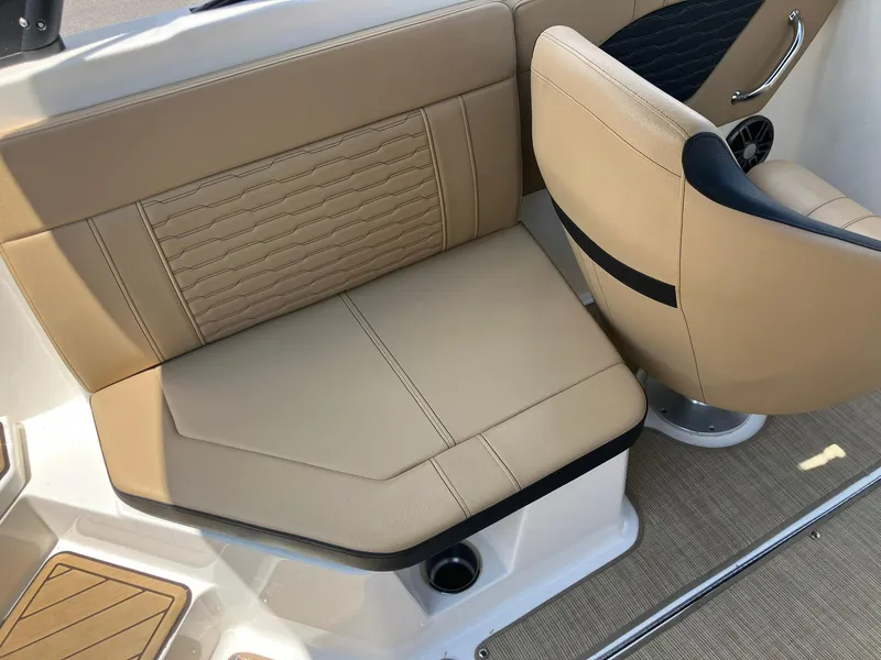 Slide: The Image of 2023 Sea Ray SPX 230 boat interior with beige seating and stylish design. - 17