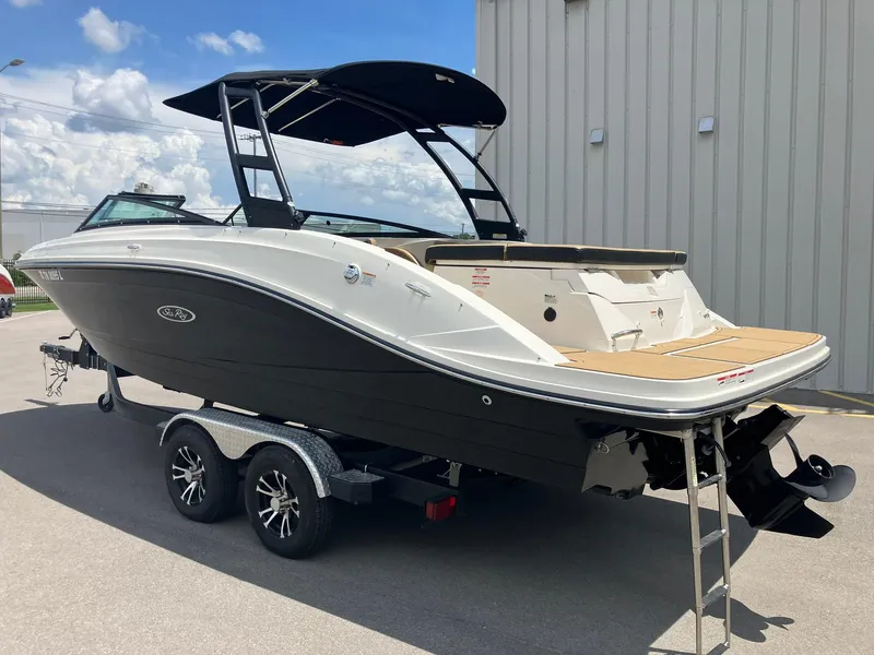 Slide: The Image of 2023 Sea Ray SPX 230 boat on trailer, black and white design, parked outdoors. - 4