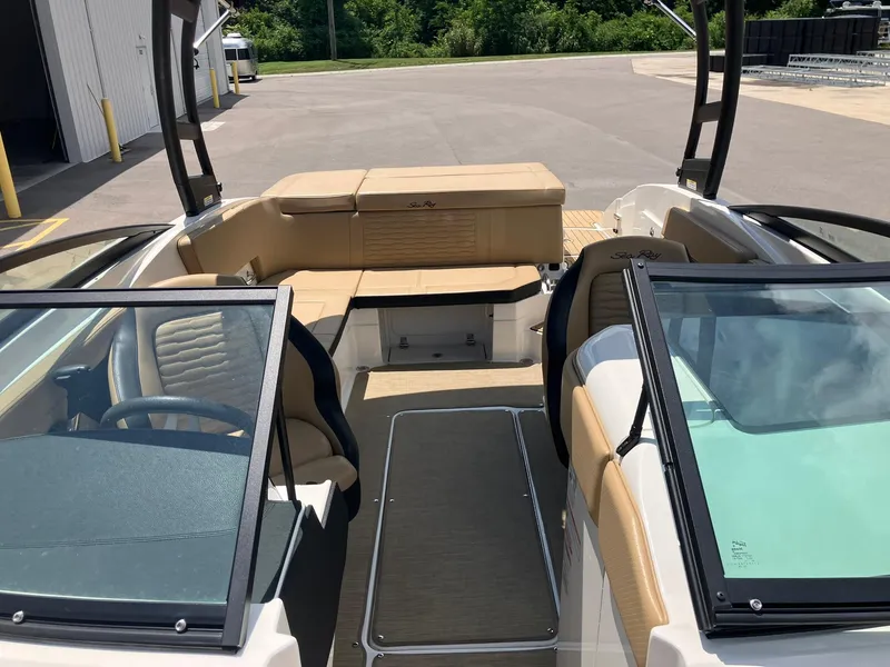 Slide: The Image of 2023 Sea Ray SPX 230 boat interior with tan seating and sleek design. - 6