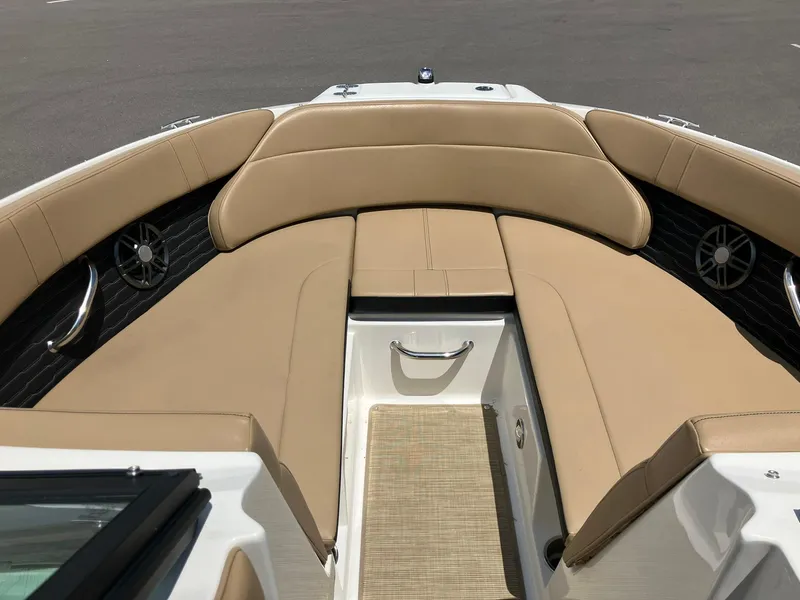Slide: The Image of 2023 Sea Ray SPX 230 boat interior with tan seating and stainless steel accents. - 7