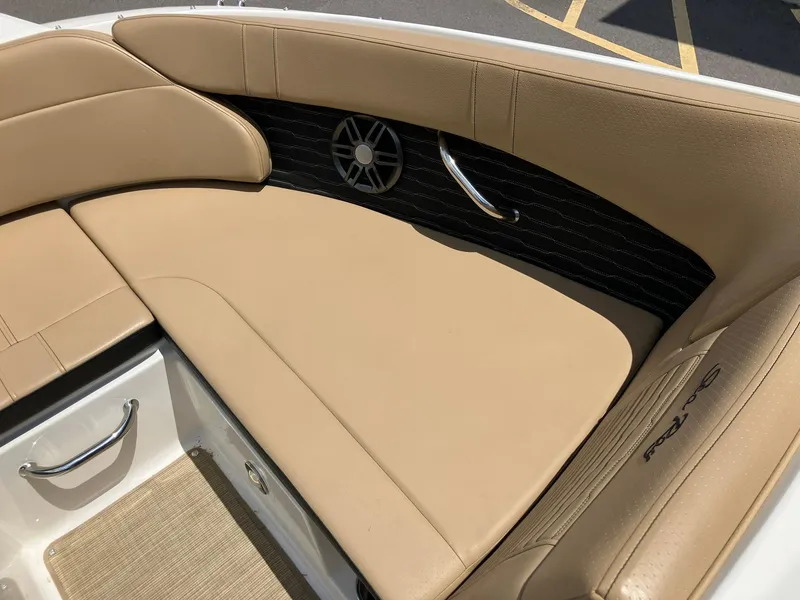 Slide: The Image of 2023 Sea Ray SPX 230 boat interior with tan seating and stainless steel accents. - 8