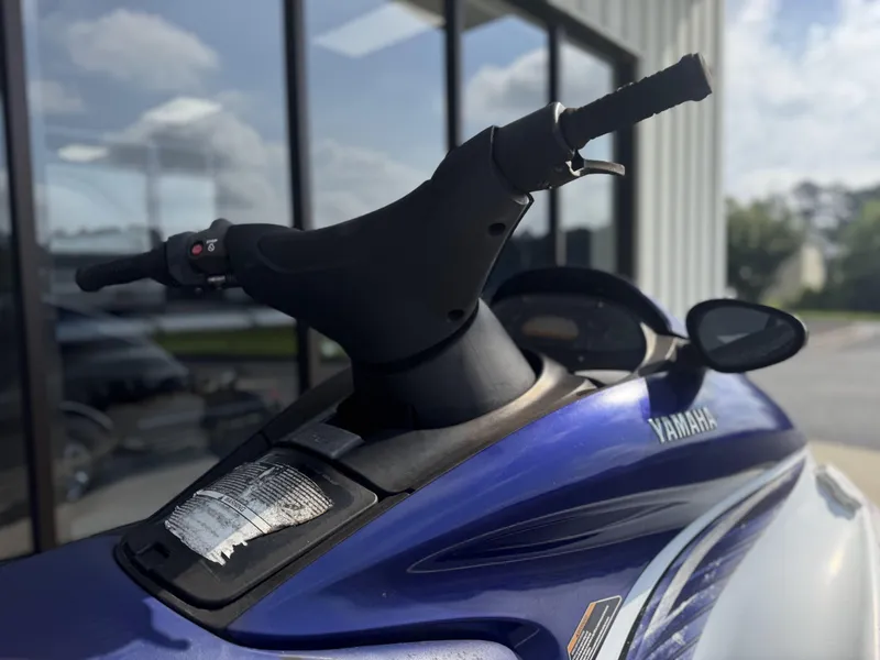 Slide: The Image of 2003 Yamaha WaveRunner FX140 jet ski, blue and white, parked outdoors. - 5