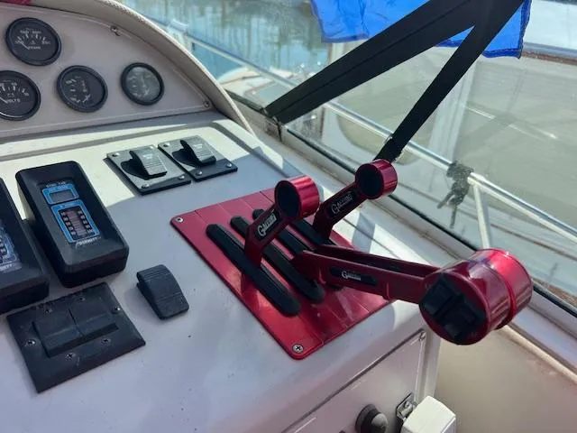 Slide: The Image of Control panel of a 1990 Donzi 300 Levante boat with red throttle levers. - 10