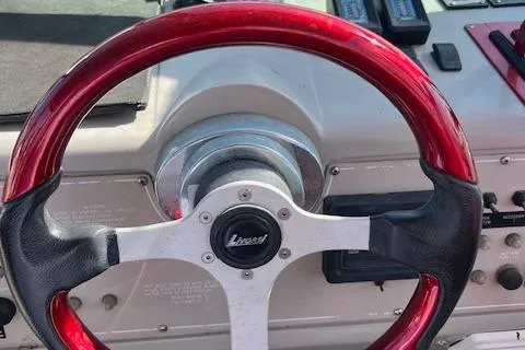 Slide: The Image of Red steering wheel of a 1990 Donzi 300 Levante boat cockpit. - 13